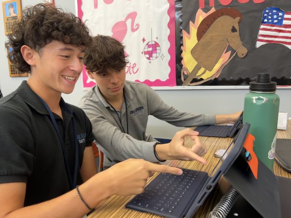 In the main lobby, seniors Ethan Saavedra and Dylan Cardoba look over their AP Calculus BC assignments and work together to understand the problems.