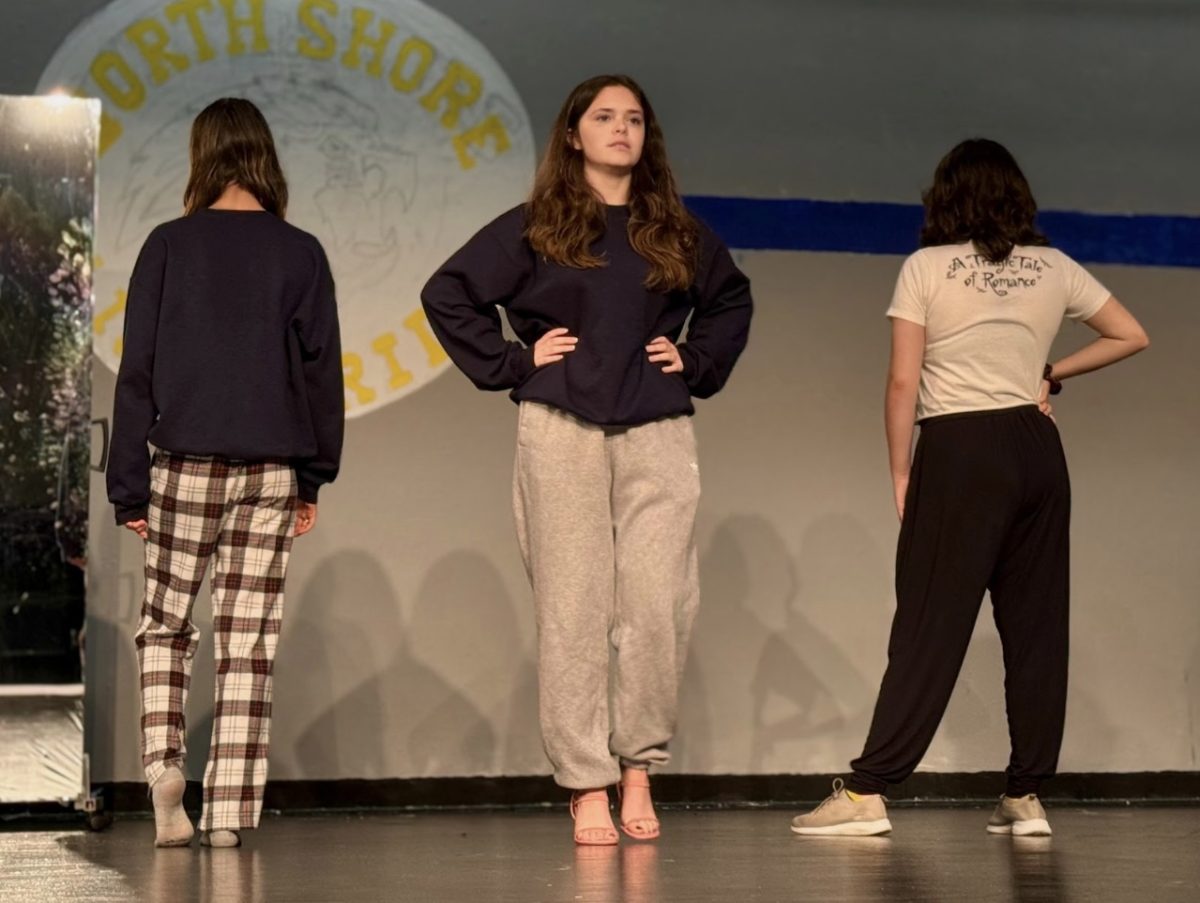The Plastics take center stage as they rehearse for our high school production of Mean Girls, with Regina George commanding attention with her fierce gaze forward. 