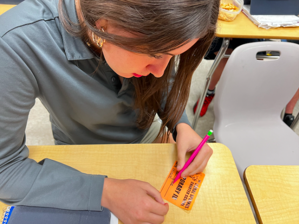 Katianna Grace is filling out a missing ID sticker in Ms. Oliveira’s classroom.  In the morning, student’s must fill out and wear this sticker to ensure faculty that they are a Coral Springs Charter student.