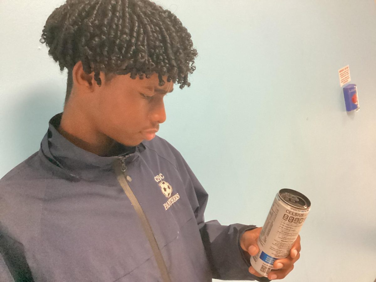 Student examining the ingredients of an energy drink called Celsius