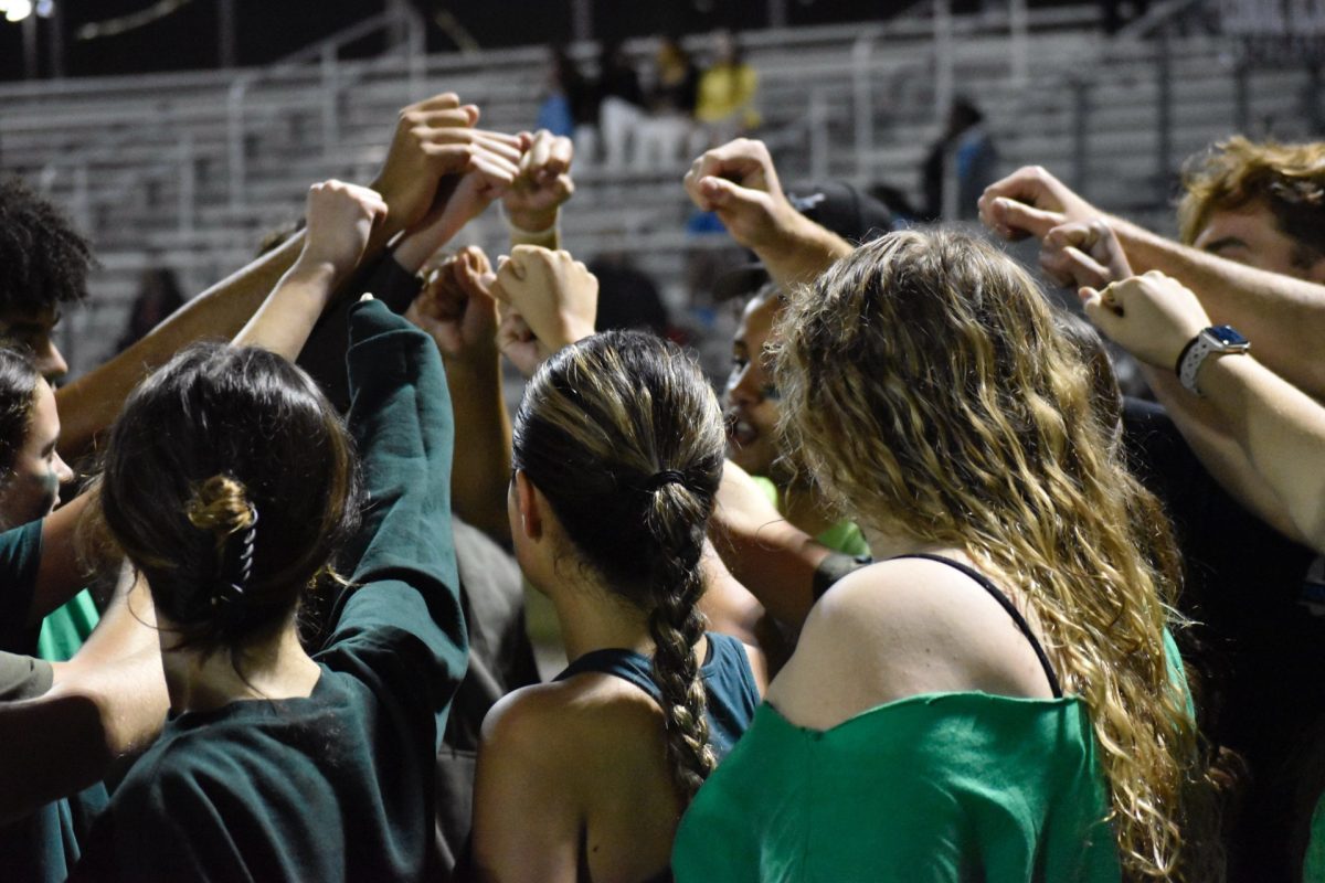 Junior Class PowderPuff team huddle during the game