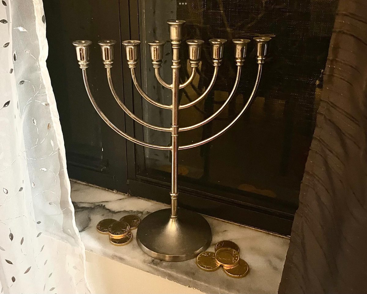 A Menorah with gelt surrounding it.