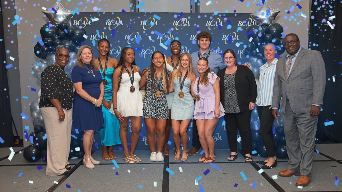 Student athletes Carson Dubich, Abby Foster, Adrianna Harris, Jaide Keen, Alexis Newland, Maria Rojas, and Jaia White at the Scholar Athlete banquet, after they received their recognitions.