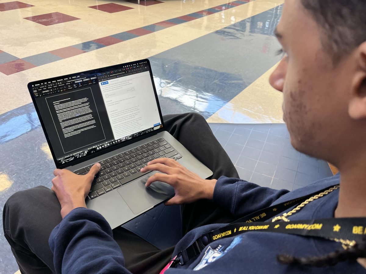 Student on a non school issued MacBook in school doing work.