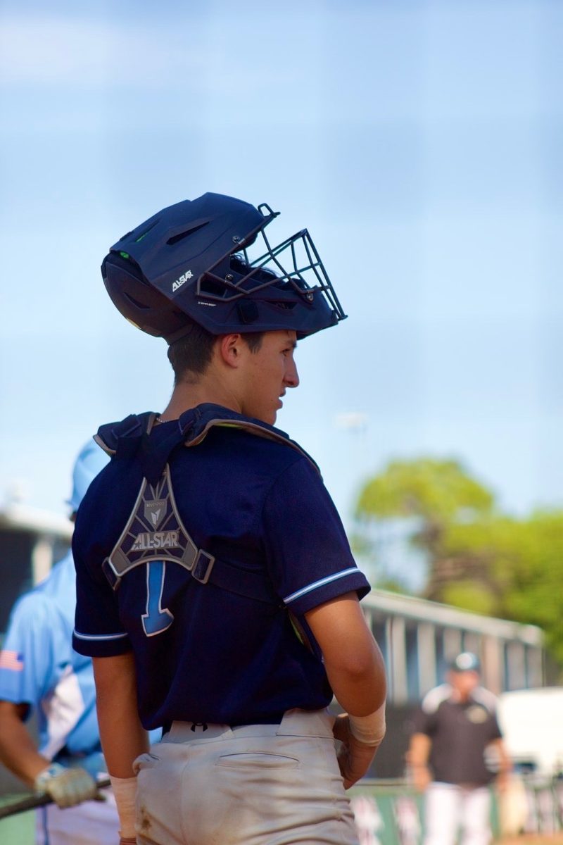 Sophomore Andres Romay catching during a high school game. This shows him preparing to catch during a game.