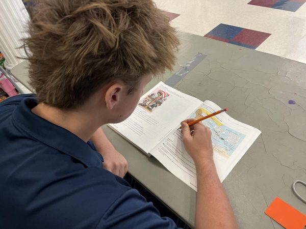 Junior Jason Webb studying for AICE history exam.