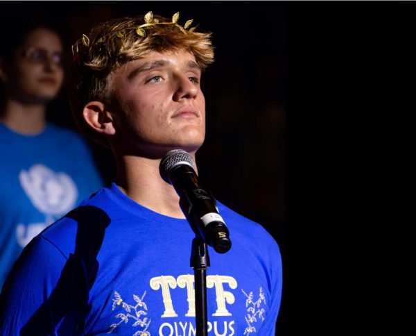 Junior Jack Webb at the front of the podium at Teen Political Forum asking questions about Coral Springs's future.